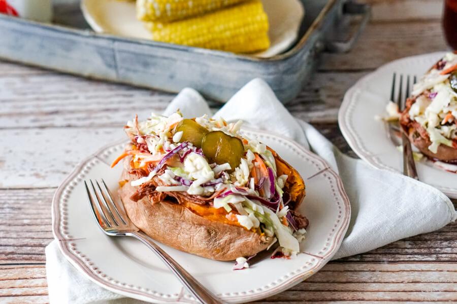 A baked sweet potato loaded with coleslaw and bbq chicken.