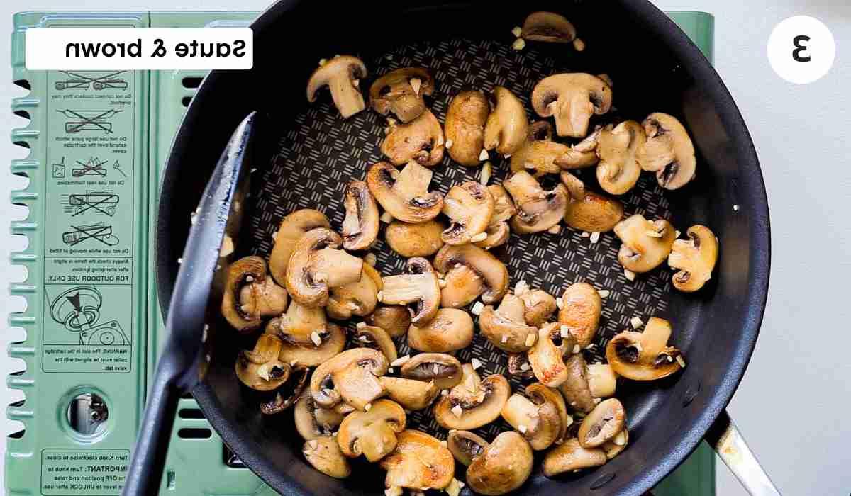 Golden sauteed mushrooms in a frying pan with caption