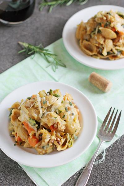 Two white plates filled with Butternut Squash Pasta with a fork to the side.