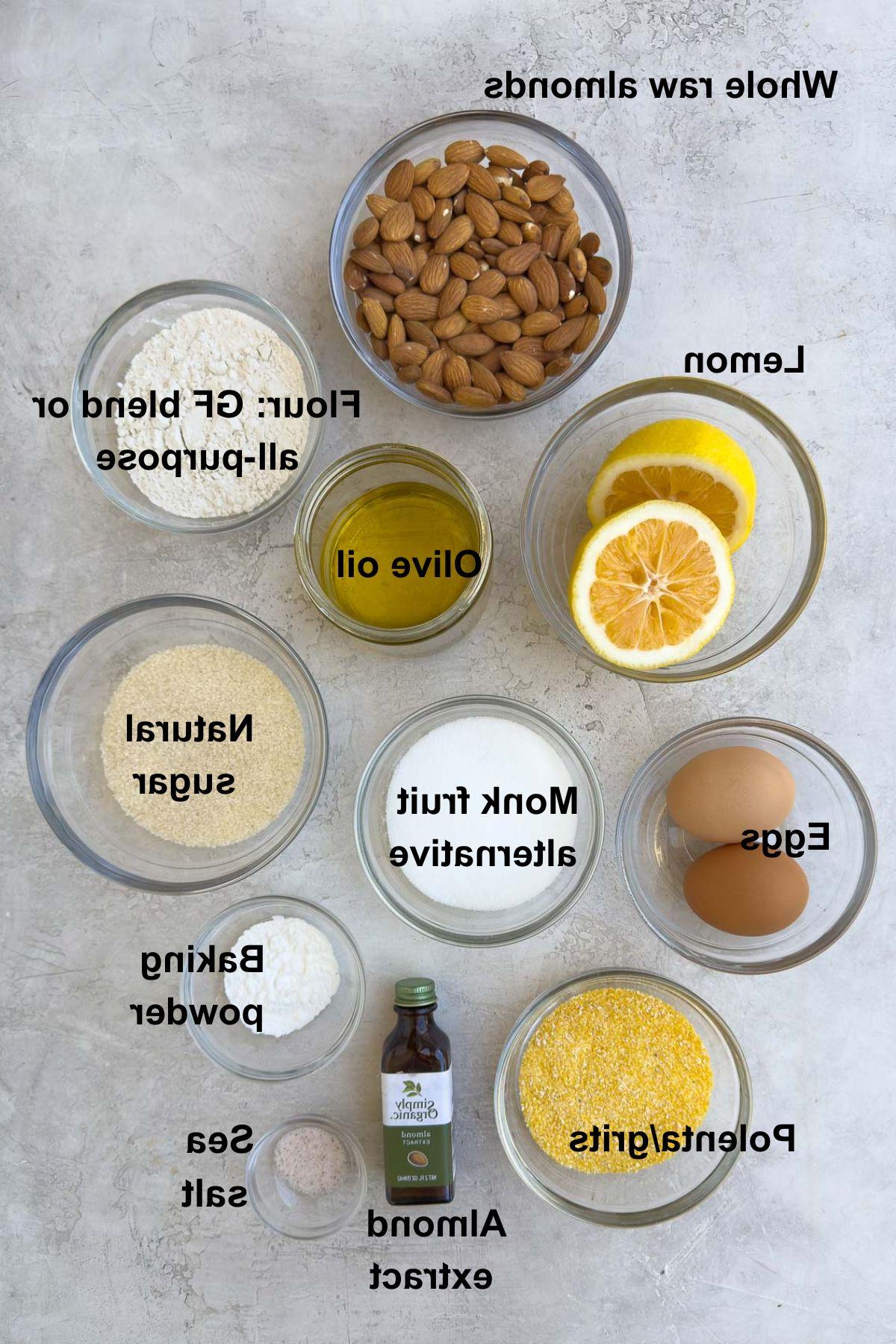 Ingredients for lemon olive oil cake in bowls on counter.