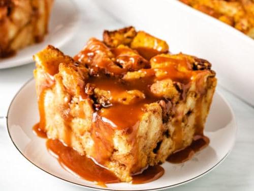 Top down view of pumpkin bread pudding with caramel on a serving dish.