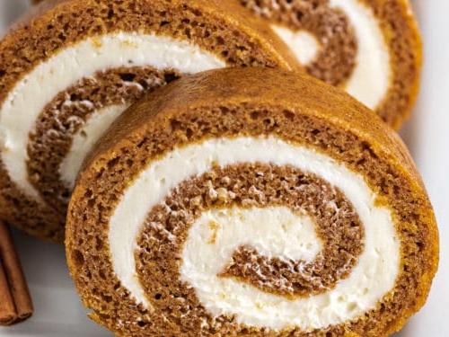Close up view of a sliced pumpkin roll.