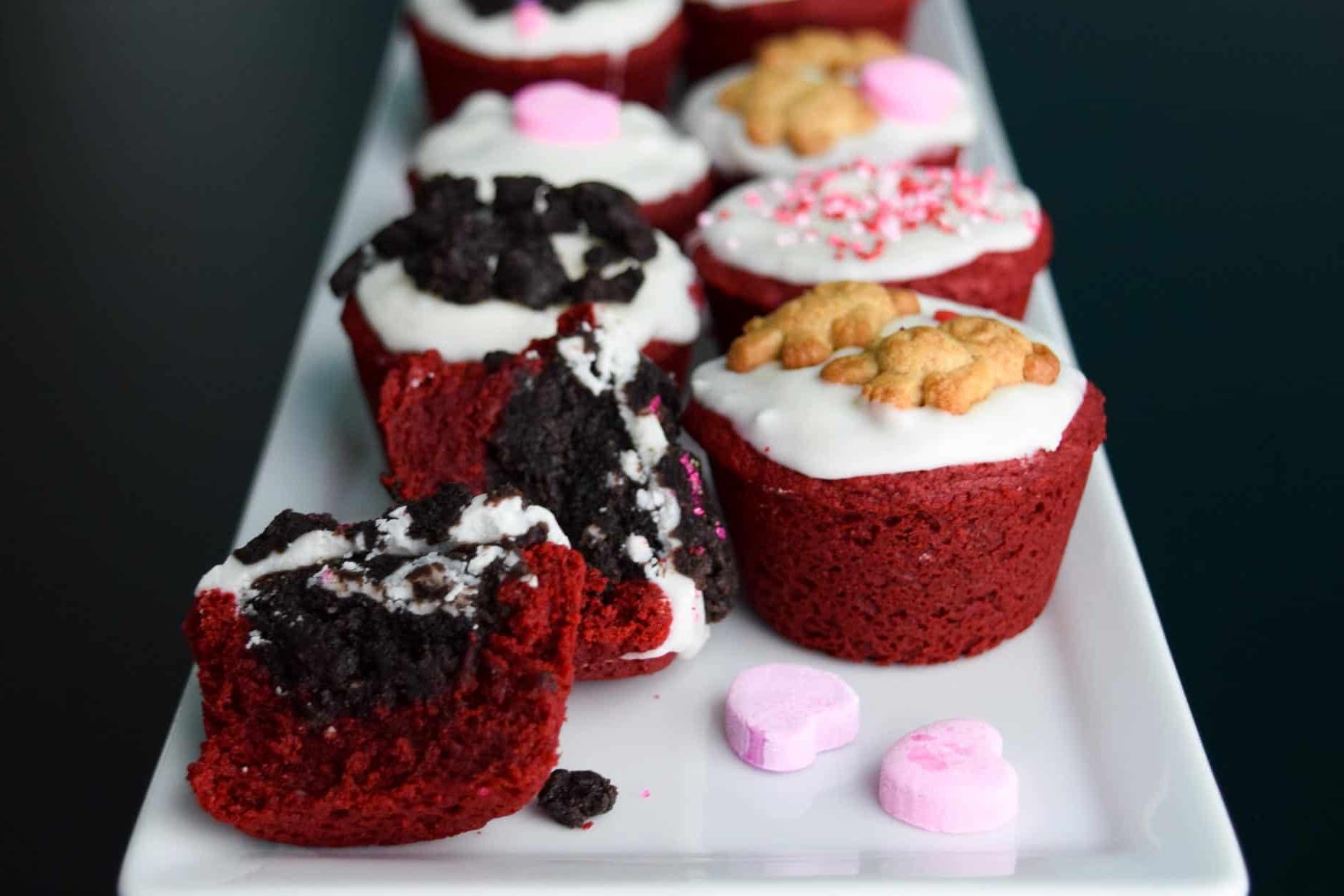 Red Velvet Oreo Valentine Cups on white platter with conversation hearts close up view