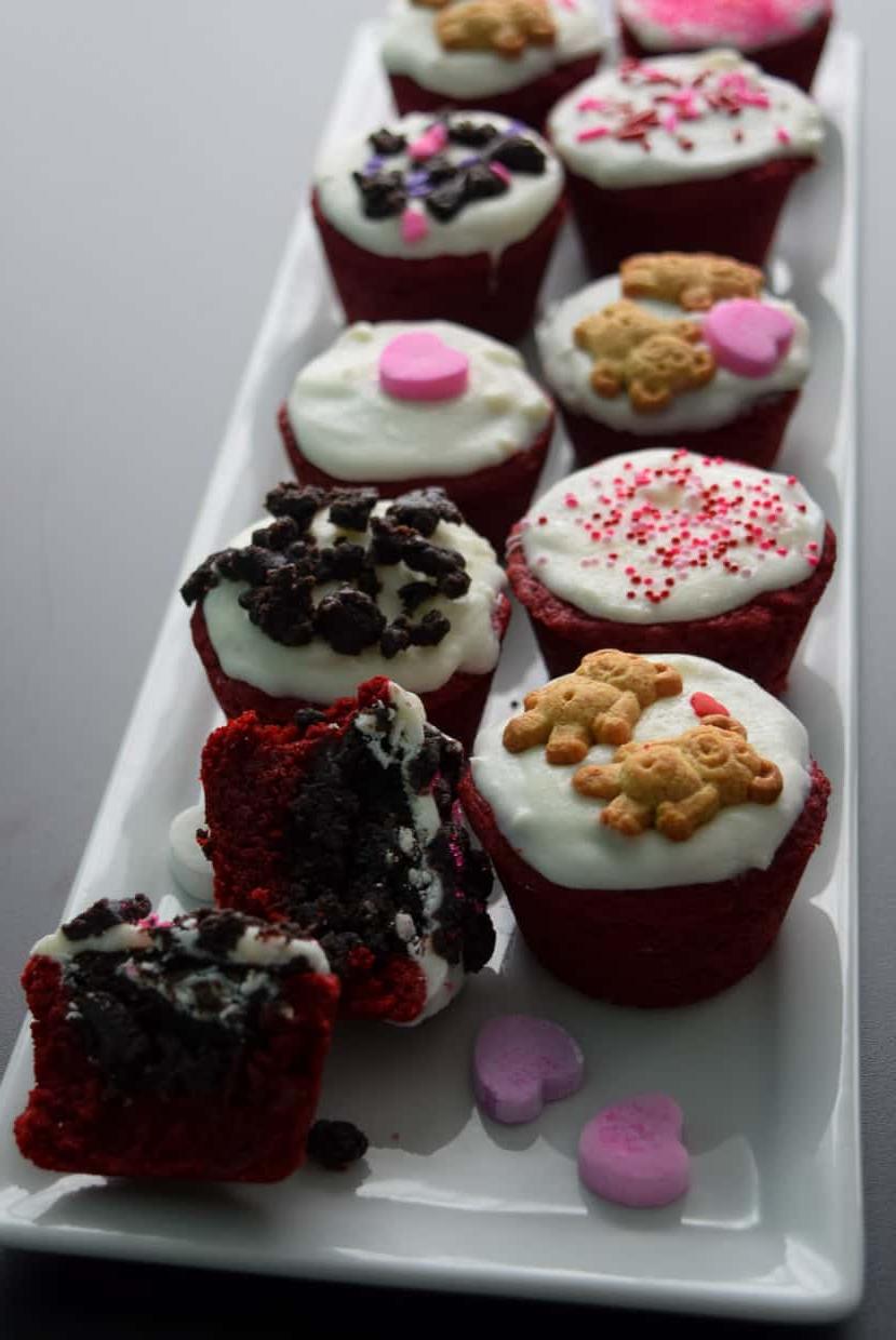 Red Velvet Oreo Valentine Cups on white platter with conversation hearts close up view