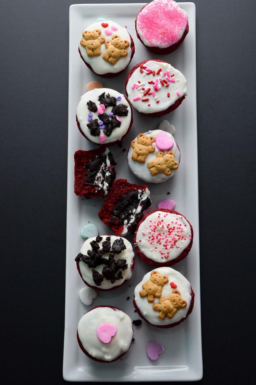 Red Velvet Oreo Valentine Cups on white platter with conversation hearts overhead shot