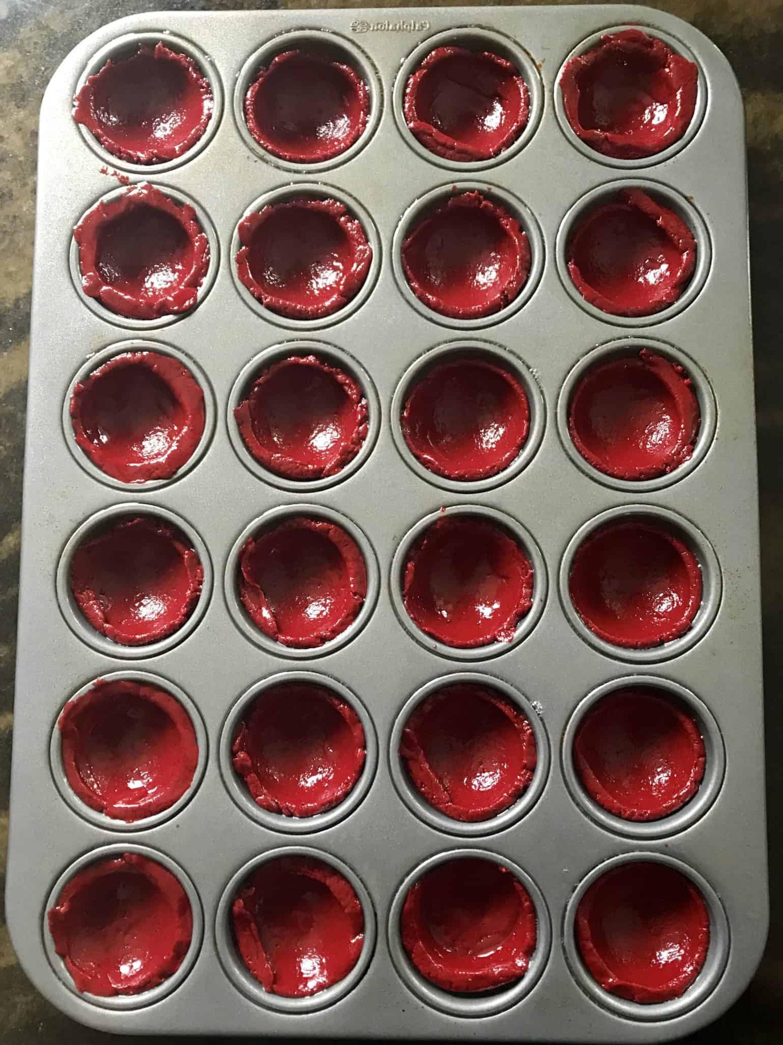 red velvet cake mix balls in mini muffin pan overhead shot ready to be baked