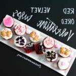 Red Velvet Oreo Valentine Cups on white platter with chalkboard writing