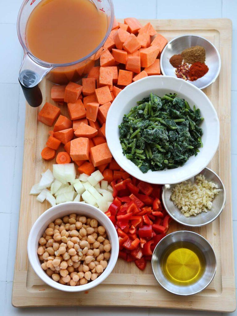 ingredients on chopping block for spiced sweet potato and spinach soup