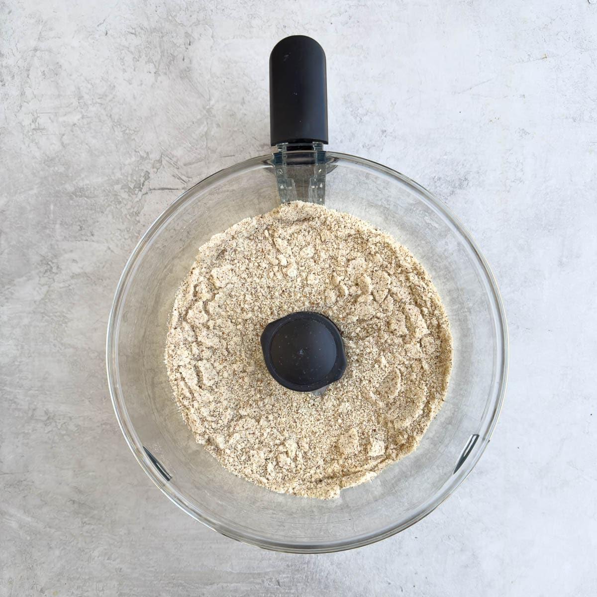 A sandy textured mix of ground almonds and sugar after processing.