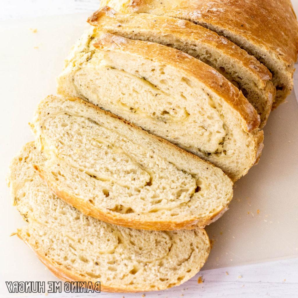 rosemary parmesan bread recipe on cutting board sliced