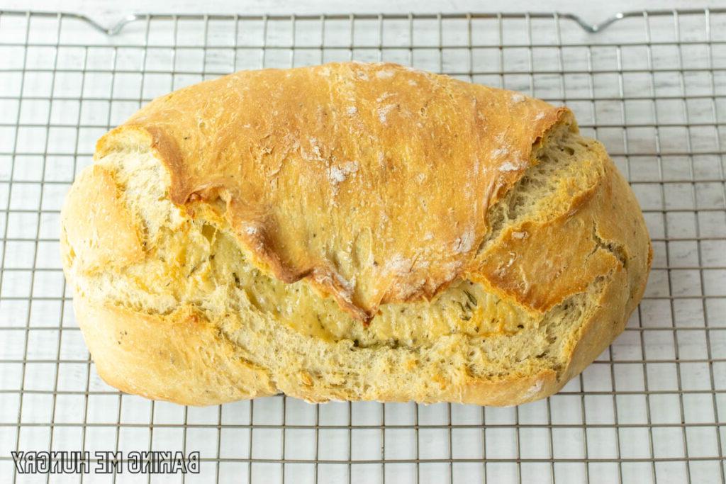rosemary parmesan bread resting on cooling rack